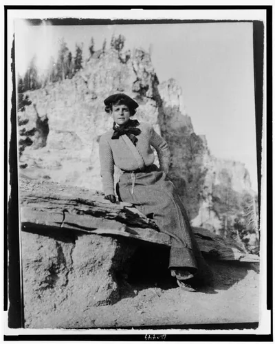 [Frances Benjamin Johnston, full-length portrait, seated on rock in…, 1903